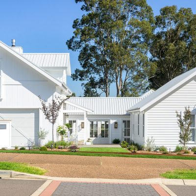 White country cottage style home barn shaped roof peeks Weathergroove Smooth 300 with battens and Primelok Federation Smooth cladding classic cottage exterior wall sheets