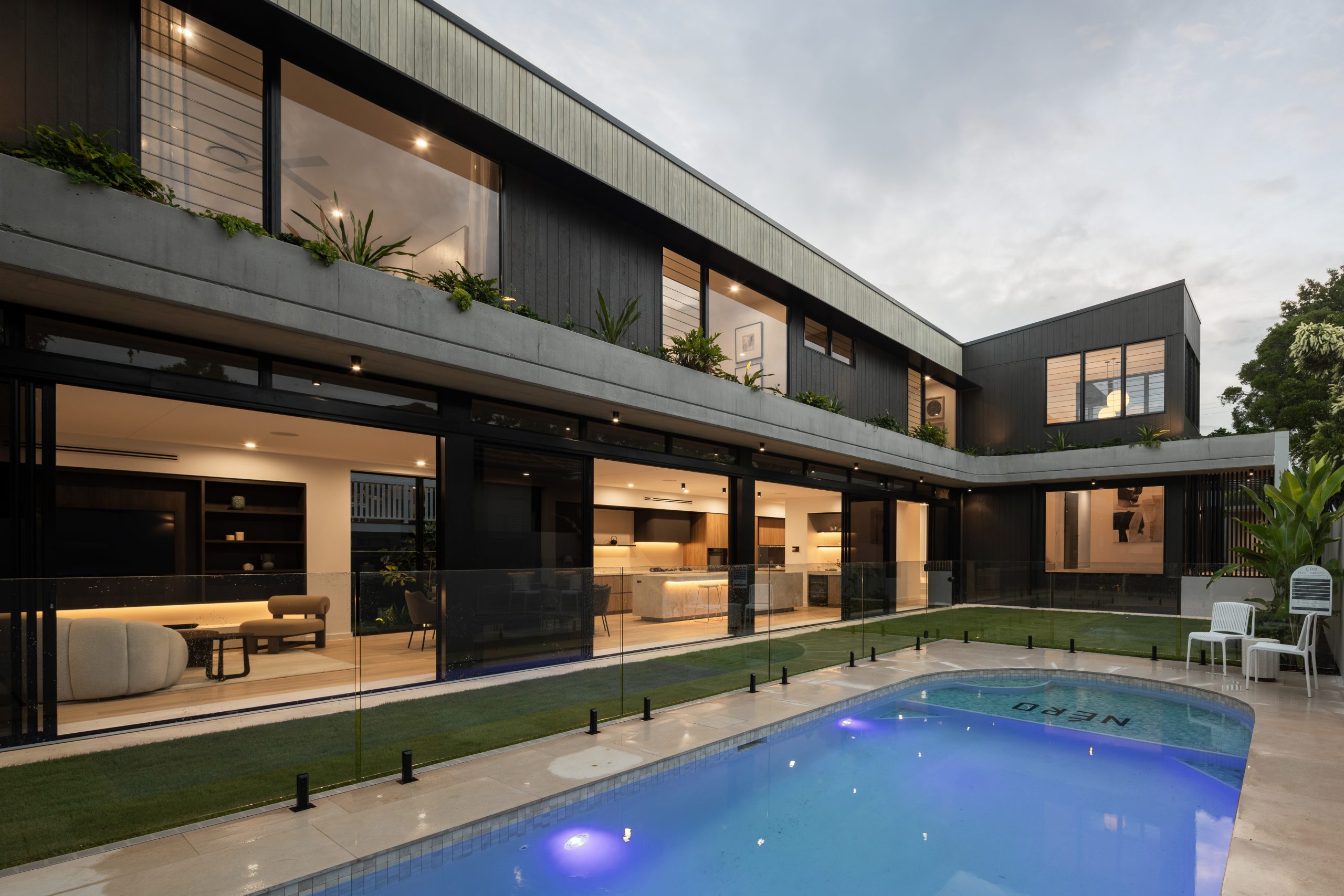 dark two story home with black vertical panels