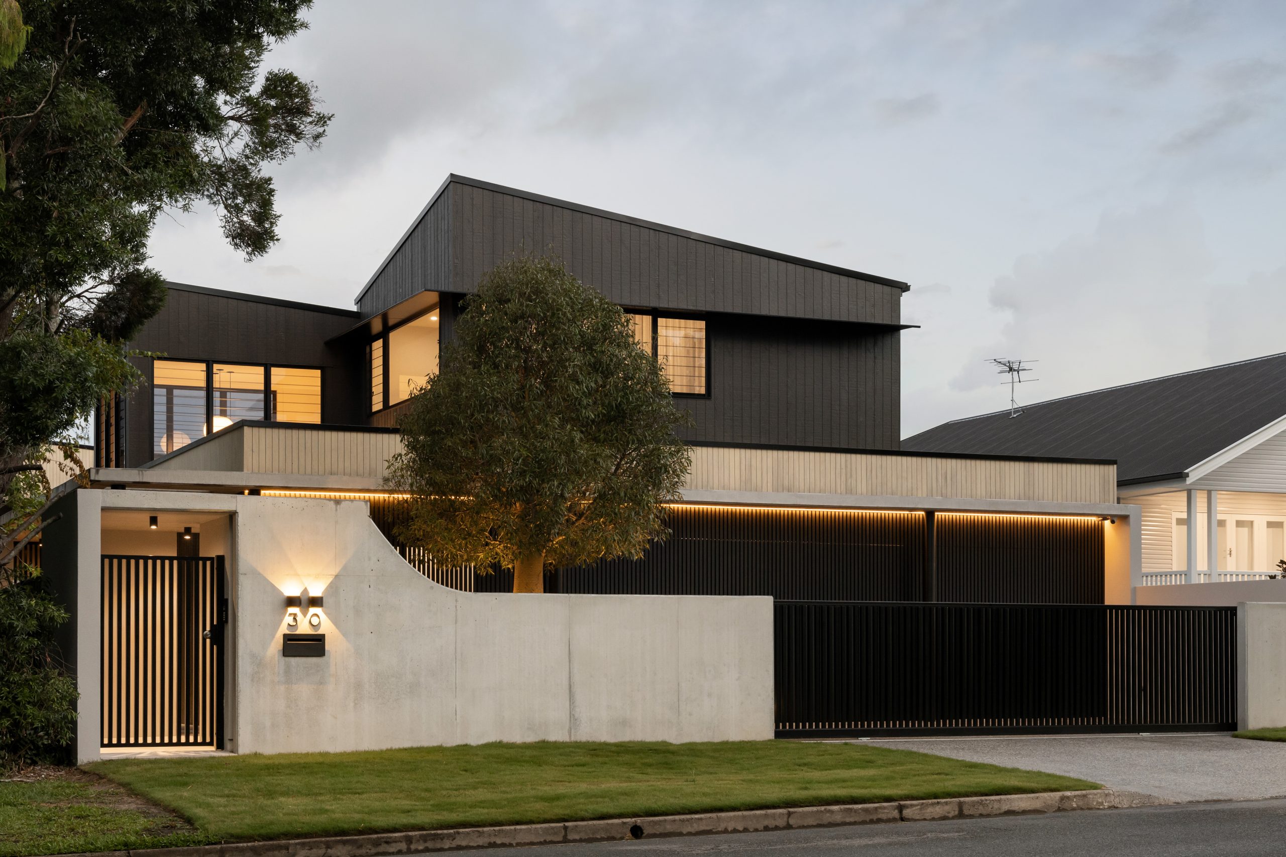dark two story home with board